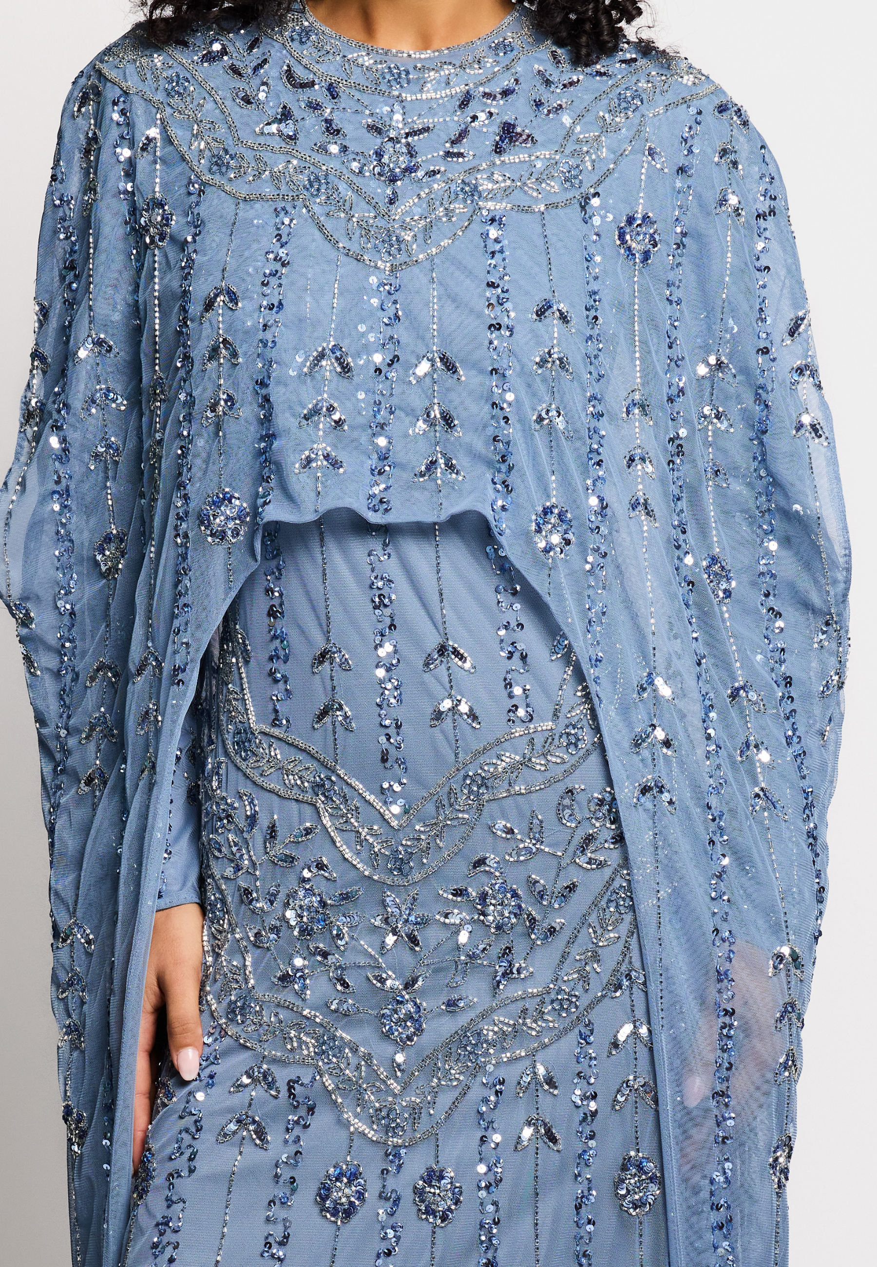 Blue beaded dress with a matching shawl on a white background